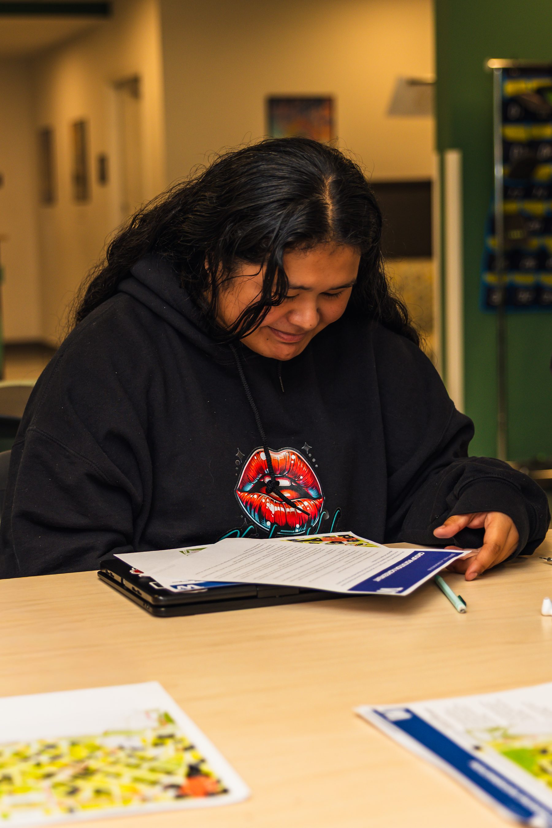 A student reading through a college handout